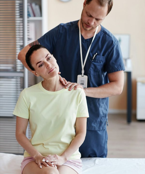 Doctor massaging patient at hospital